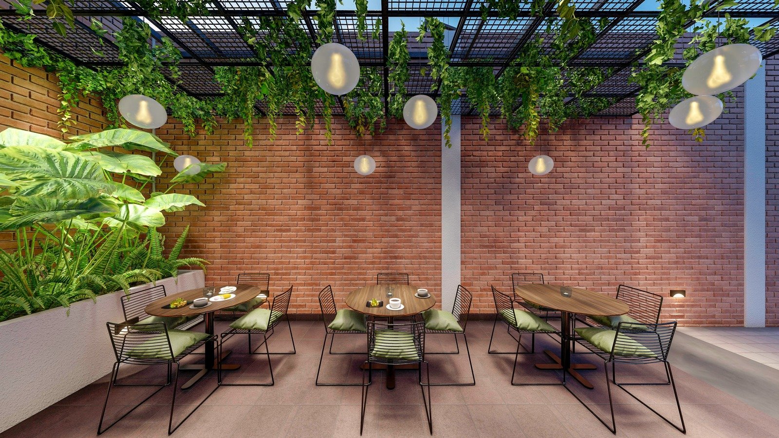 Cozy outdoor cafe tables against an exposed brick wall, shaded by a trellis with lush hanging vines and globe lights